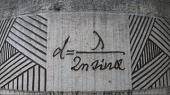 Ernst Abbe's formula for the diffraction limit, set in stone at a monument in Jena. Source: Wikpedia Creative Commons.